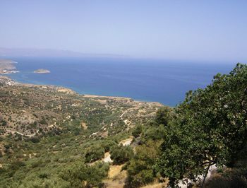 Scenic view of sea and mountains against clear sky