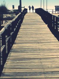 People walking on footbridge