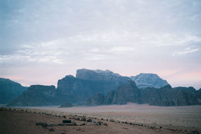 Scenic view of mountains against cloudy sky