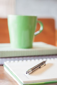 Close-up of pen and book on table