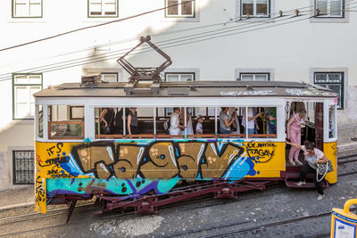 Graffiti on wall by railroad tracks