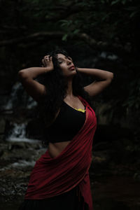 Portrait of young woman standing outdoors