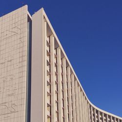 Low angle view of built structure against clear blue sky