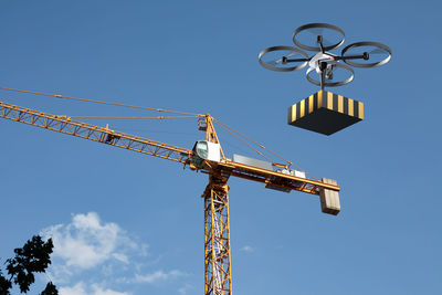 Drone helping construction crane in lifting equipment