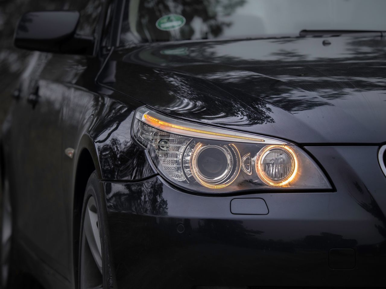 CLOSE-UP OF ILLUMINATED VINTAGE CAR