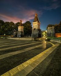 Illuminated building against sky at dusk