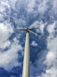 Low angle view of wind turbine against cloudy sky