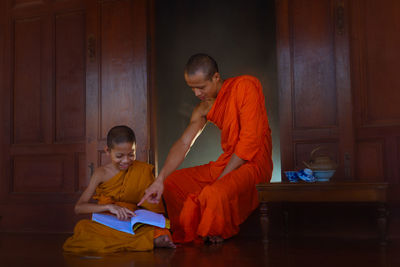 Monk teaching boy in monastery