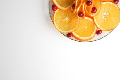 Directly above shot of orange fruit against white background