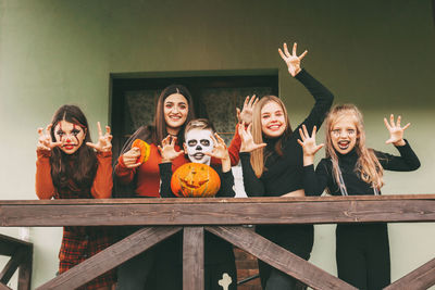 A group of children celebrating halloween on the street near the house in nature in costumes 