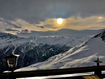 Scenic view of snowcapped mountains against sky during sunset