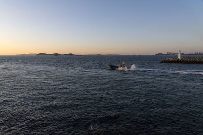 Scenic view of sea against clear sky during sunset