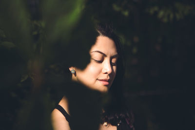 Portrait of beautiful young woman with eyes closed