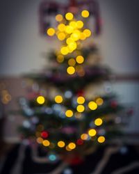 Defocused image of illuminated christmas tree at night