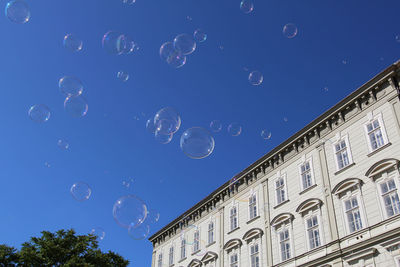 Low angle view of bubbles against clear sky