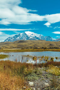 Scenic view of lake and mountains against sky