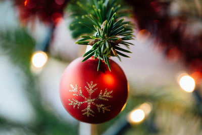 Close-up of red bauble on christmas tree