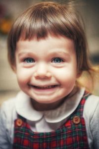 Close-up of cute blonde little girl with blue eyes smiling