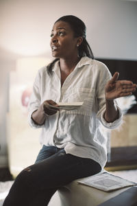 Mid adult woman looking away while sitting at home