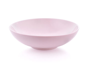 Close-up of empty pink bowl over white background