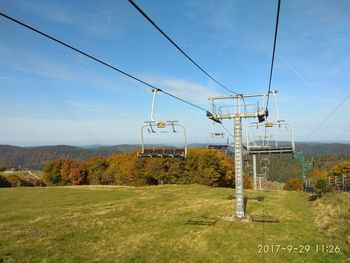 Overhead cable car against sky