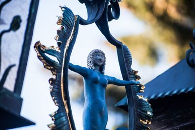 Close-up of statue against blue metal