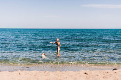 Full length of men on beach against sky