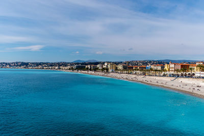 Scenic view of sea by city against sky