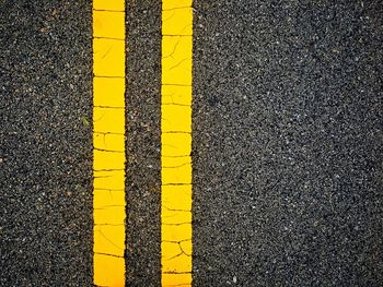 Directly above shot of yellow road marking