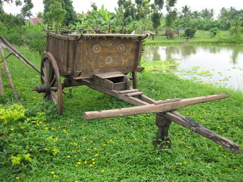 Built structure on grass against trees
