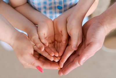 Large european family holding hands together close-up. happy family of five