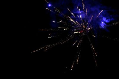 Low angle view of firework display at night