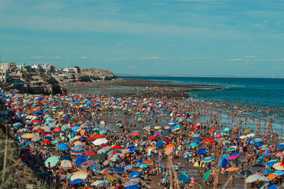 High angle view of people at beach against sky