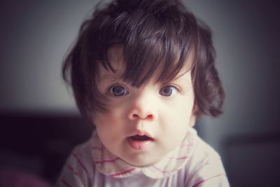 Close-up portrait of cute baby girl at home