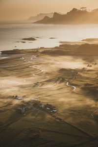 High angle view of beach against sky during sunset