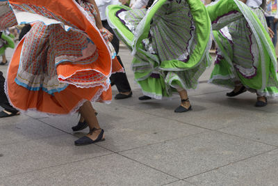 Low section of people dancing on tiled floor