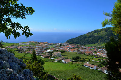 Houses in village against blue sky