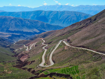 High angle view of road amidst mountains against sky