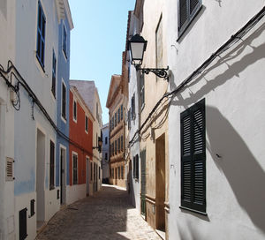 Narrow street amidst buildings against sky