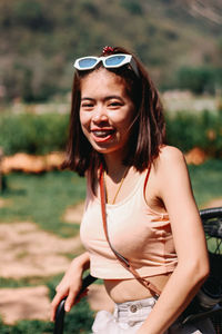 Portrait of smiling young woman wearing sunglasses