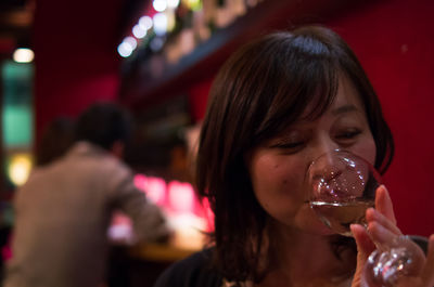 Woman drinking wine at bar