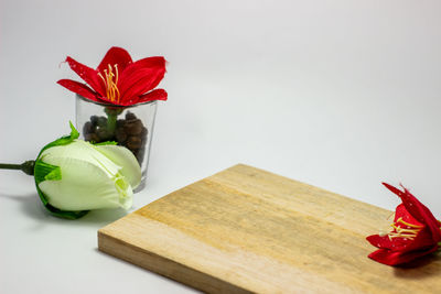 Close-up of red rose on table