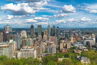 High angle view of modern buildings in city against sky