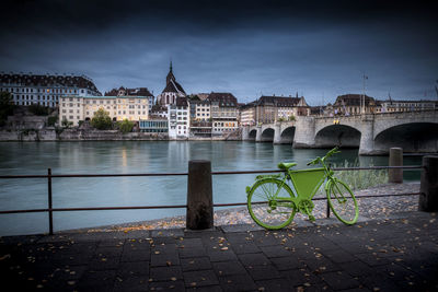 Bridge over river in city against sky