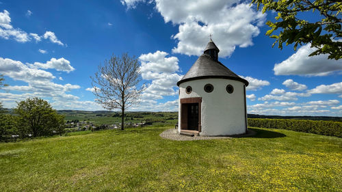 Built structure on field against sky