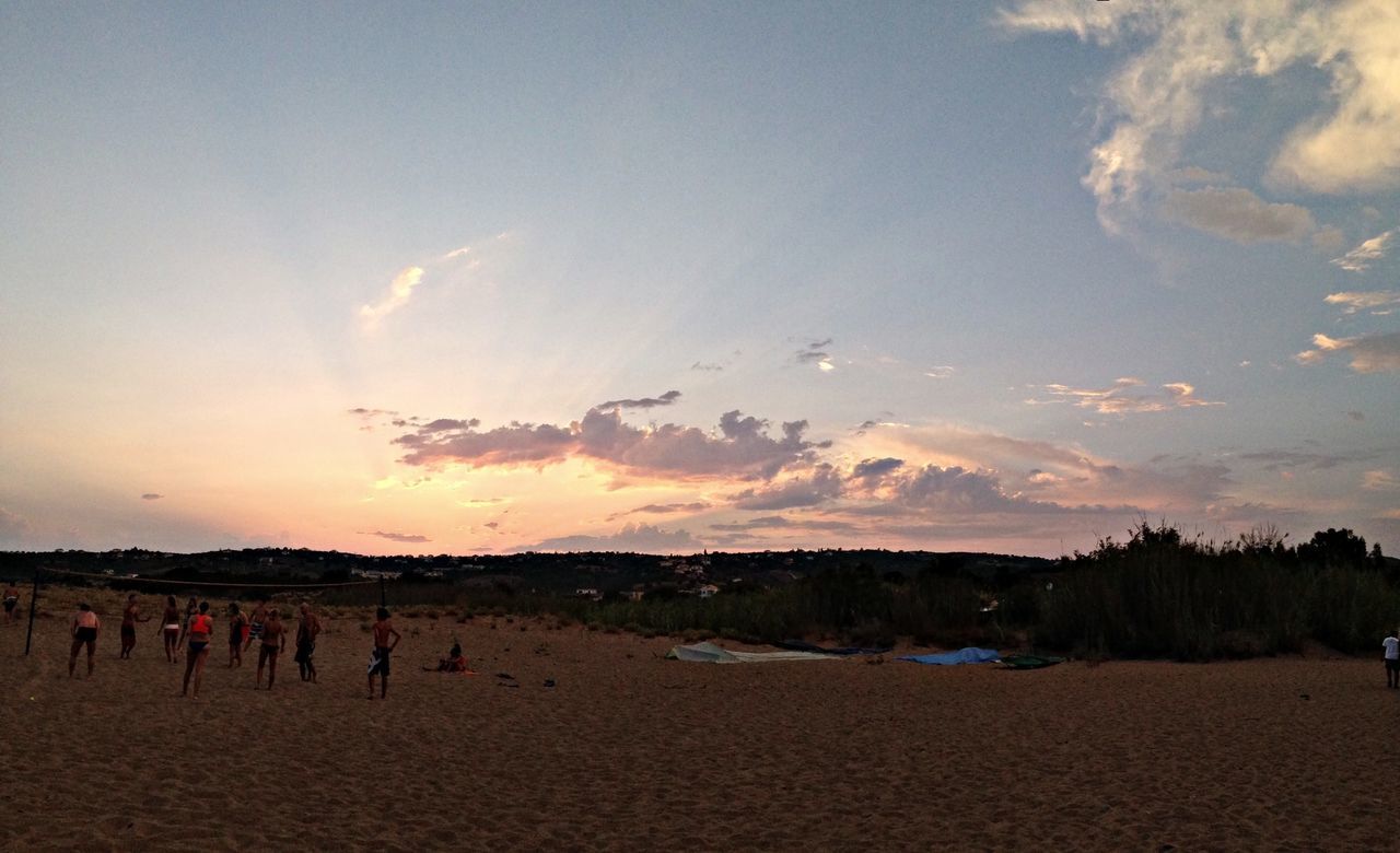 sky, sunset, beach, scenics, cloud - sky, tranquil scene, beauty in nature, large group of people, tranquility, sand, nature, cloud, shore, sea, idyllic, landscape, vacations, outdoors, silhouette