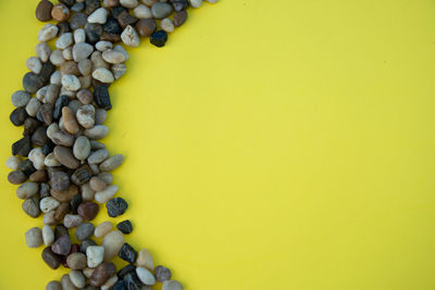 High angle view of chopped candies against yellow background