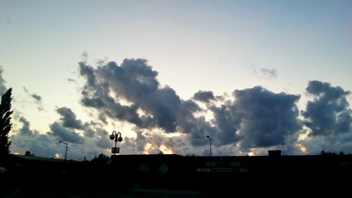 Low angle view of built structure against sky at sunset