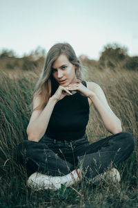 Young woman sitting on field