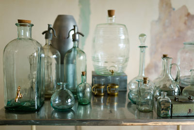 High angle view of glass bottles on table against wall